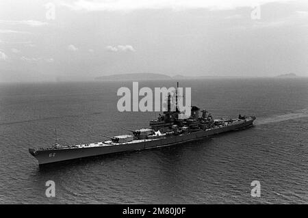 Aerial port bow view of the battleship USS NEW JERSEY (BB-62) underway prior to entering Manila Bay, Republic of the Philippines. Country: South China Sea
