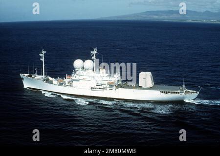 An aerial port view of the missile range instrumentation ship USNS OBSERVATION ISLAND (T-AGM 23) underway off the coast Hawaii. Country: Pacific Ocean (POC) Stock Photo