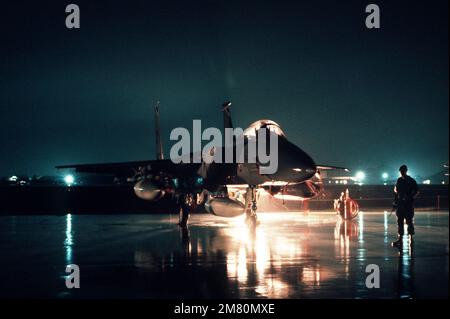 A nighttime right front view of an F-15 Eagle aircraft on the ramp. Base: Naval Air Facility, Misawa State: Aomori Country: Japan (JPN) Stock Photo