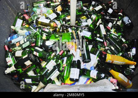 Waste glass containers filled with empty bottles Stock Photo