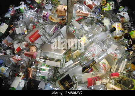 Waste glass containers filled with empty bottles Stock Photo