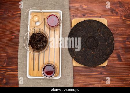 Chinese tea ceremony pressed pu erh wooden table top view copy space morning energy. Stock Photo