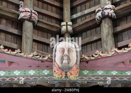 A representation of Cardinal Morton's face carved into a ceiling boss of the unique oak roof of St John the Baptist’s Church in Bere Regis, Dorset, UK. Stock Photo