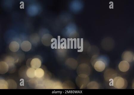 Blurred magic fairy lights with an abstract bokeh effect against a dark background Stock Photo