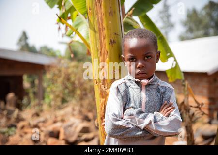 Portrait of an african man with Down syndrome is in an African village.  Stock Photo