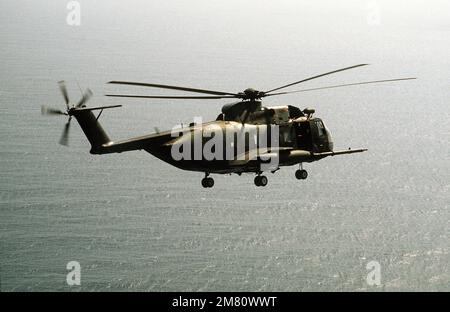 An air-to-air right side view of an HH-3E helicopter assigned to the 33rd Aerospace Rescue and Recovery Squadron, Kadena Air Base, Japan. Country: Unknown Stock Photo