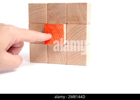 Pressing red button wooden cube with your finger Stock Photo