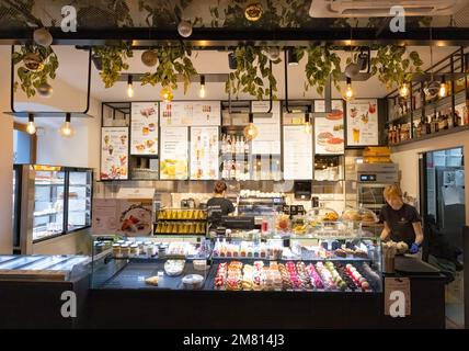 Krakow Cafe interior; Waitresses behind the counter in a cafe serving tea, coffee and cakes near the market square, Krakow Old Town, Krakow Poland Stock Photo