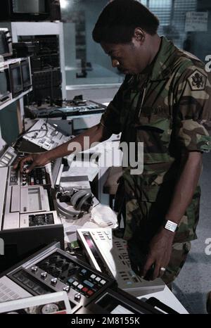 Sergeant 1ST Class Nathaniel McBride operates video editing equipment ...