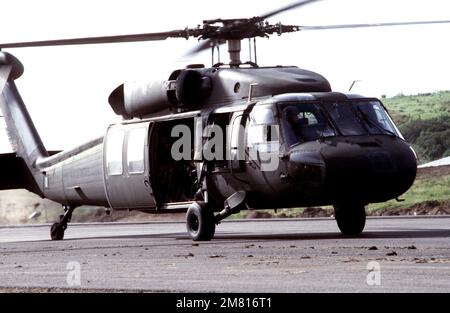 Right front view of a UH-60 Black Hawk helicopter with members of the Eastern Caribbean Defense Force aboard during Operation URGENT FURY. Subject Operation/Series: URGENT FURY Country: Grenada (GRD) Stock Photo
