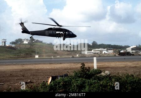 Right side view of a UH-60 Black Hawk helicopter transporting members of the Eastern Caribbean Defense Force during Operation URGENT FURY. Subject Operation/Series: URGENT FURY Country: Grenada (GRD) Stock Photo