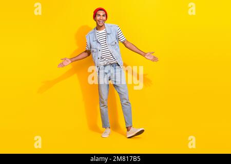 Full length photo of impressed funky man wear jeans outfit rising arms crossed isolated yellow color background Stock Photo