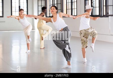 Four dancers exercising swing movements Stock Photo
