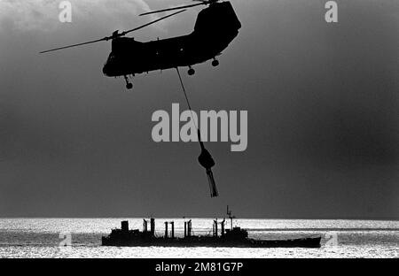 A UH-46 Sea Knight helicopter provides replenishment service to ships positioned off the coast of Lebanon. The ships are supporting US Marines assigned to the multinational peacekeeping force in Beirut. Country: Mediterranean Sea (MED) Stock Photo