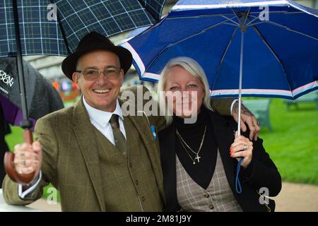 Ascot, Berkshire, UK. 2nd October, 2021. Racegoers with their umbrellas enjoying racing at Ascot. Credit: Maureen McLean/Alamy Stock Photo