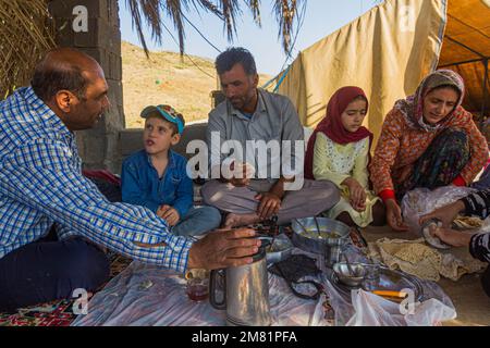 ZAGROS, IRAN - JULY 8, 2019: Nomad family having breakfast in Zagros mountains, Iran Stock Photo