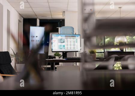 Workplace with modern electronic screen for staff meetings and conferences in a financial analysis company. Chairs in waiting room with relaxed style in the background. Stock Photo