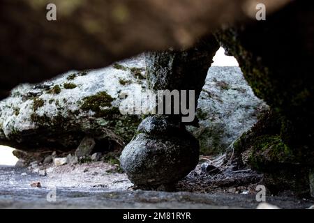 A peculiar round rock formation on the underside of a large boulder. Stock Photo