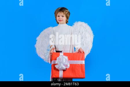 Valentines Day. Little angel with present box. Cupid with white wings in valentine day with gift. Stock Photo