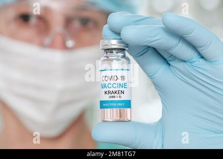 Woman doctor holding a vial with coronavirus vaccine Covid19 Kraken variant Stock Photo