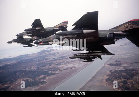 An air-to-air left underside view of four F-4E Phantom II aircraft from the 51st Tactical Fighter Wing, 36th Tactical Fighter Squadron, in formation during the joint US/South Korean Exercise TEAM SPIRIT '84. The aircraft are equipped with AN/ALQ-119 electronic countermeasures pods and Sidewinder (AIM-9) missiles. Subject Operation/Series: TEAM SPIRIT '84 Country: Republic Of Korea (KOR) Stock Photo