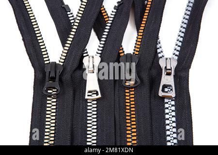 Jacket Winter Coat Black Tape Heavy Duty Zippers Large Molded Plastic Zippers. Close-up of zipper slider on a white surface. Sewing production, materi Stock Photo