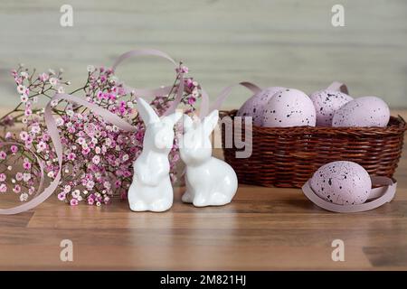 Easter background with colored Easter eggs and blooming flowers. Two Easter Bunnies. Easter composition. Easter. Copy space Stock Photo