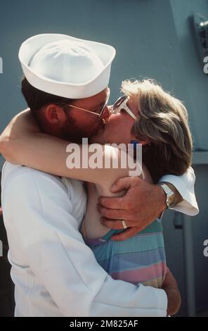 Electrician's Mate 2nd Class (EM2) Brian Pickett hugs his wife, Monnie, upon returning to home port after 11 months at sea aboard the battleship USS NEW JERSEY (BB 62). Base: Naval Air Station, Long Beach State: California (CA) Country: United States Of America (USA) Stock Photo