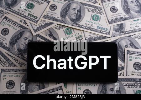 ChatGPT logo seen on smartphone and blurred US dollars on the background.  Chat GPT is a new AI chatbot by Open AI. Stafford, United Kingdom, January Stock Photo