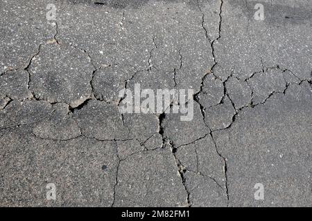 Asphalt surface of the roadway in bad condition needs repairs top view close up Stock Photo