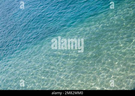 Marine water surface, sun's rays shimmer on water surface, diagonal lines, top view Stock Photo