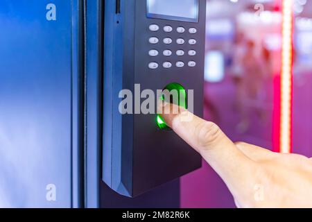 Staff push down electronic control machine with finger scan to access the door of or data center. The concept of data security or data access control. Stock Photo