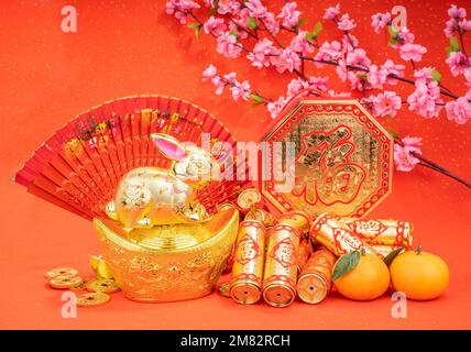 Tradition Chinese golden rabbit statue,2023 is year of the rabbit,Chinese characters on decoration translation: good bless for new year. Stock Photo