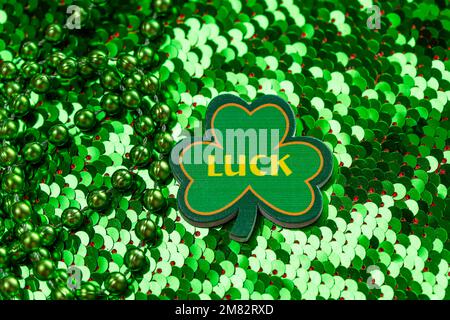 Green shamrock for St. Patricks Day on sequin background Stock Photo