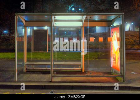 isolated empty bus stop at night on street sidewalk Stock Photo