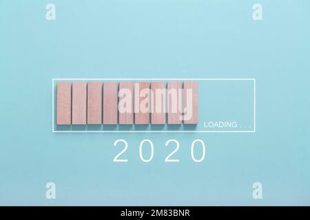 Loading new year 2020 concept , Showing loading bar with wood cube on bluebackground Stock Photo