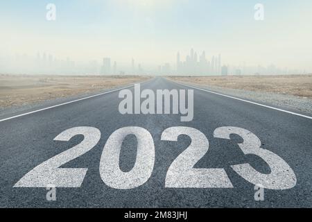 2023 written on highway road in the middle of empty asphalt road and beautiful blue sky. Concept for vision new year 2023. future vision 2023 Stock Photo