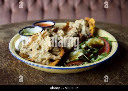 Patacón with chicken breakfast. The patacón, tostón, tachino or frito is a meal based on fried flattened pieces of green plantain Stock Photo