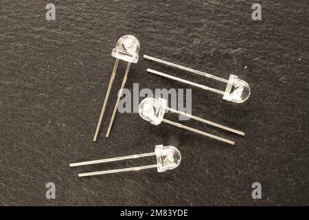 Four LEDs on slate stone, macro, top view. Stock Photo