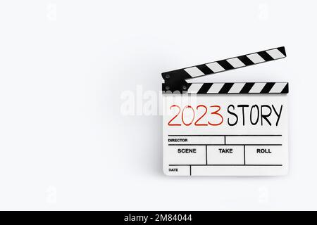 2023 story. handwriting on film slate or movie clapboard.Happy new year film industry. Stock Photo