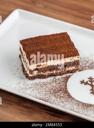 Gourmet Italian dessert tiramisu on dark wooden table Stock Photo