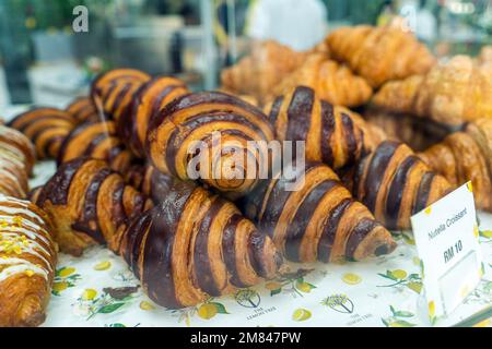 Kuala Lumpur, Malaysia - December 11th, Croissants and baked pastries on display at cafe. Stock Photo