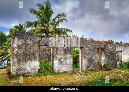 The shell of an unfinished, abandoned concrete building on the tropical island of Rarotonga, Cook Islands Stock Photo