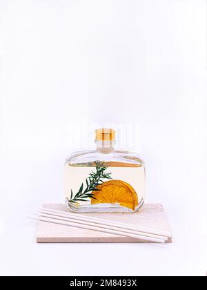 Reed diffuser with cinnamon and orange on white background. High quality photo Stock Photo