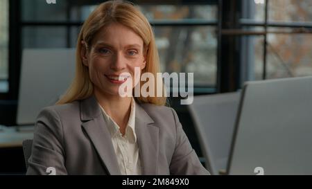 Headshot close up business portrait female smiling businessperson Caucasian adult middle-aged businesswoman happy with career corporate achievement Stock Photo