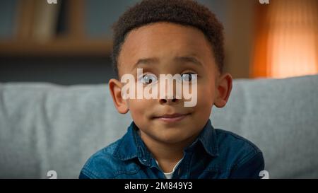 Portrait sad cute African American ethnic multiracial multiethnic child orphan small boy pupil son baby toddler serious 7 years kid looking at camera Stock Photo