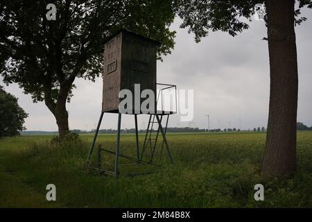Watchtower on cloudy day, hunting tower and hunting grounds Stock Photo