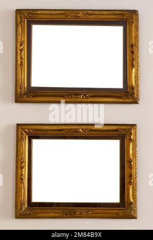Antique golden frame isolated on white background. Old wooden frame with floral carvings painted with gold paint. Italian heritage and antiquities Stock Photo