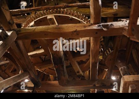 Huge wooden gear, the mechanism of an old mill Stock Photo