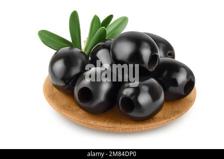 Black olives with leaves in wooden bowl isolated on a white background with full depth of field. Stock Photo